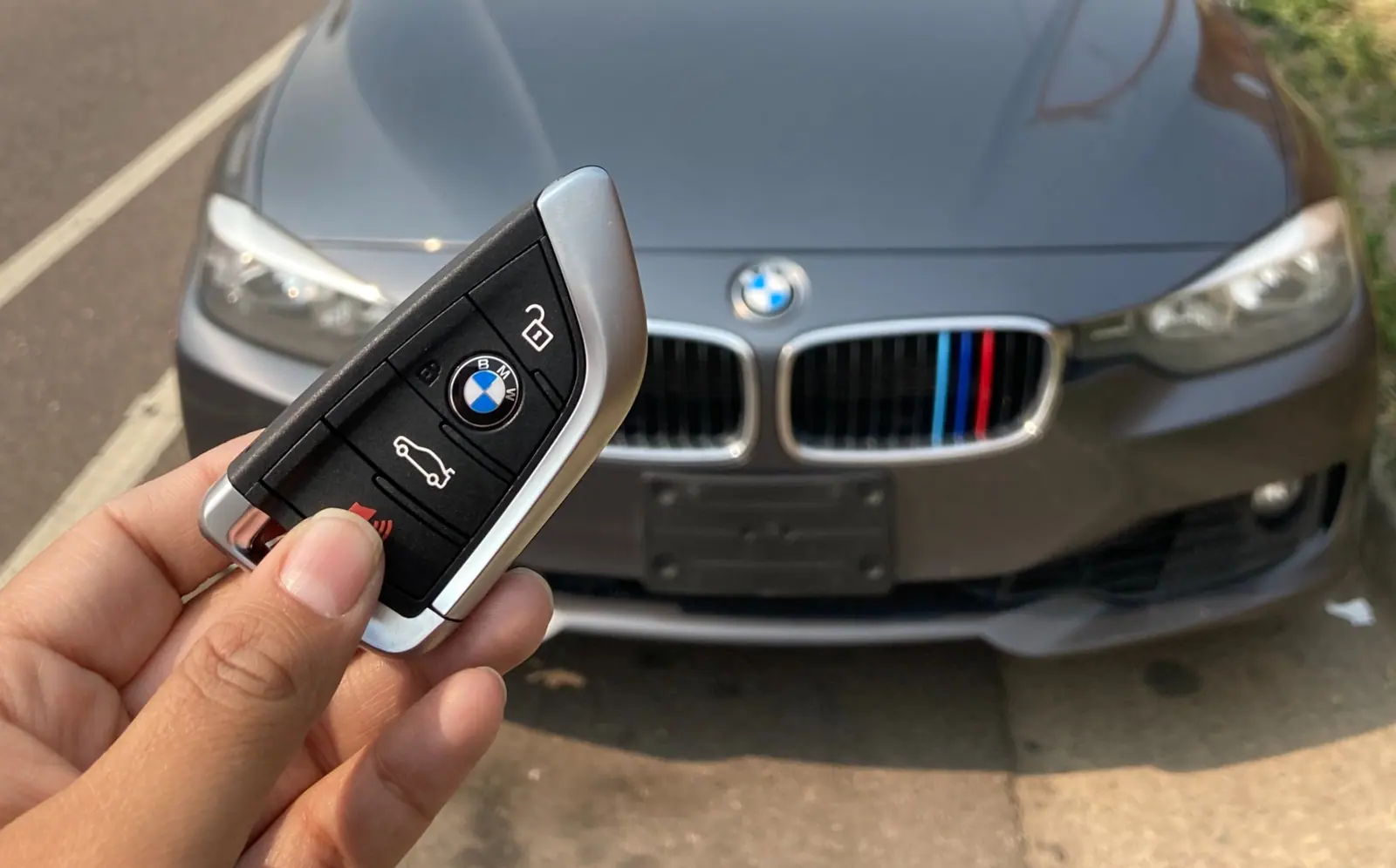 BMW key beside the customer’s vehicle